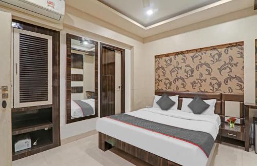 a bedroom with a bed and a large window at Hotel Tirupati Galaxy in Kānpur