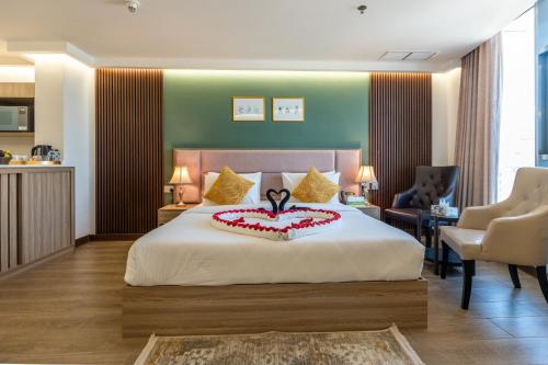 a bedroom with a bed with a cake on it at Al Salam Hotel in Kuwait