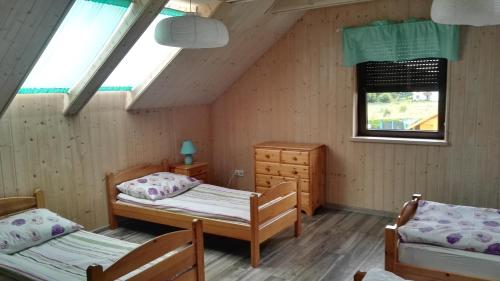 a room with two beds and a window at 11 Maków in Mielenko