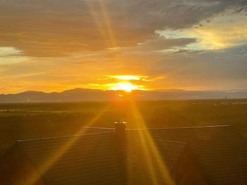 a sunset with the sun setting in the sky at Vogesenblick in Bad Bellingen