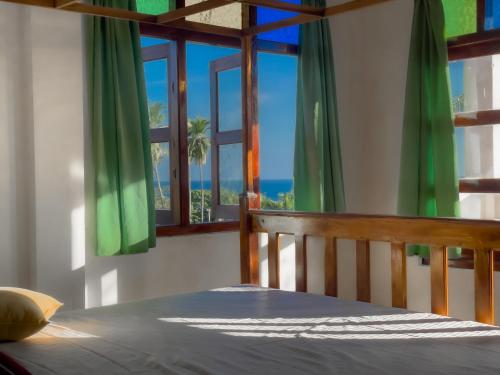 a bedroom with a bed with a view of the ocean at Summer lodge-Tangalle in Tangalle