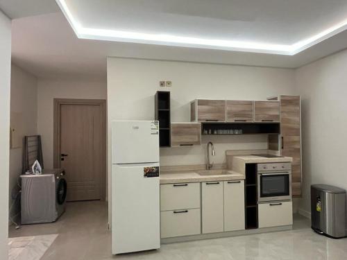 a kitchen with a white refrigerator in a room at فيلا ساره in Al Madinah