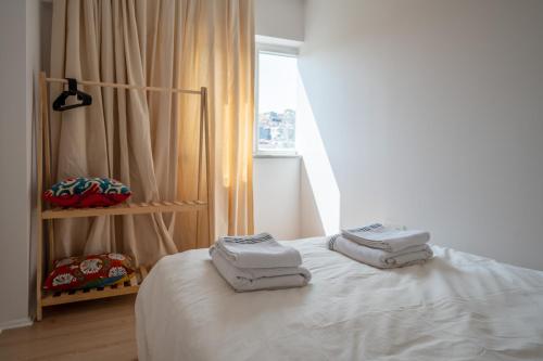 a room with a bed with towels on it at Nomado Residence with gym in Istanbul