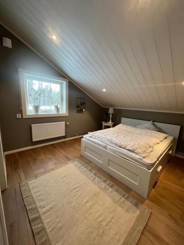 a bedroom with a large bed in a attic at Mysig lägenhet på landet. in Ljung