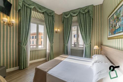 a bedroom with a bed with green curtains at HOTIDAY Hotel Roma Porta Pia in Rome