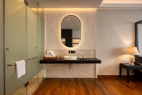 a bathroom with a sink and a mirror at Taprobane House in Colombo