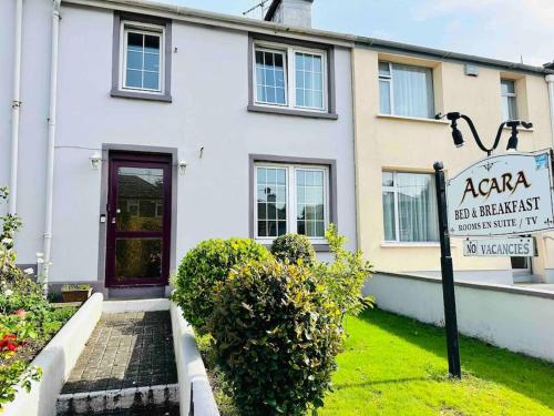 a white building with a sign in front of it at Wonderful Town House where are current President Connolly has stayed while visiting town in Killarney