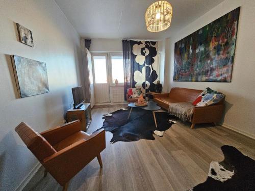 a living room with a couch and a table at Rovio Retrohome in Jyväskylä