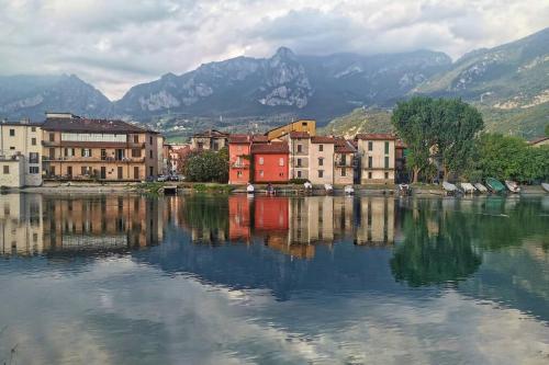 a group of buildings sitting next to a body of water at The River Nest in Lasnigo