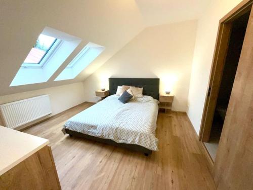 a bedroom with a bed and two skylights at Apartmán č.5 v bankovním domě in Kutná Hora