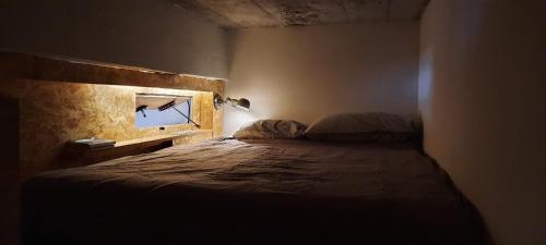 a bedroom with a bed with a window in it at Cosy 4p Loft & CoWorking space 5m walk to ski lift in Briançon