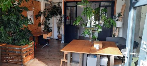a room with a table and some potted plants at Cosy 4p Loft & CoWorking space 5m walk to ski lift in Briançon