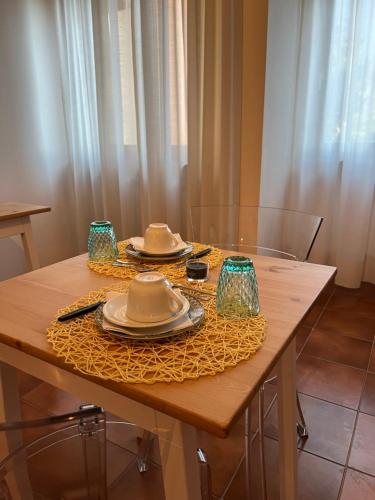 a table with plates and hats on top of it at Aniene Home Roma in Rome