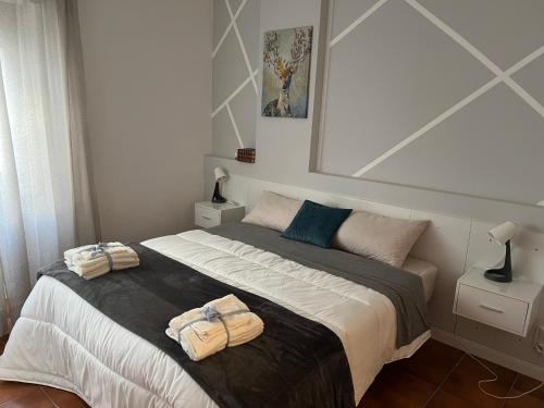 a bedroom with a large bed with towels on it at Aniene Home Roma in Rome