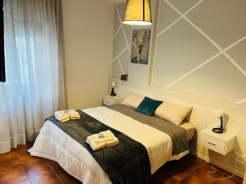 a bedroom with a bed with towels on it at Aniene Home Roma in Rome