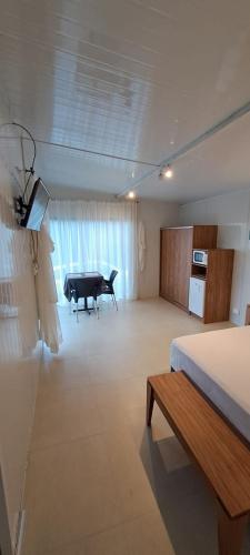 a bedroom with a bed and a piano in a room at Mirador las Colinas in Paraguarí