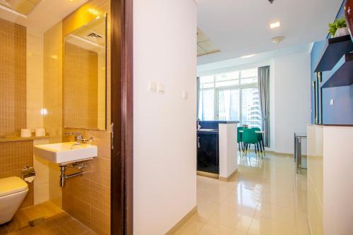 a bathroom with a sink and a toilet and a table at Modern Sea View 1Bedroom Dubai Marina in Dubai