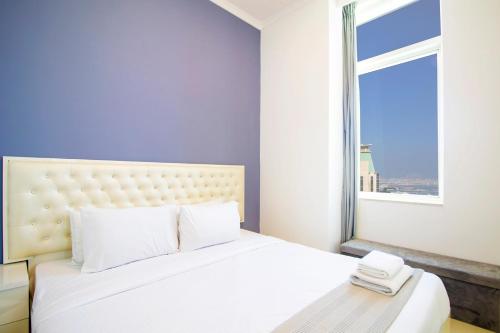 a bedroom with a white bed with a large window at Modern Sea View 1Bedroom Dubai Marina in Dubai