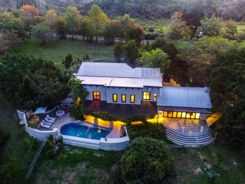 an aerial view of a house with a swimming pool at The Good Earth Farm in The Crags