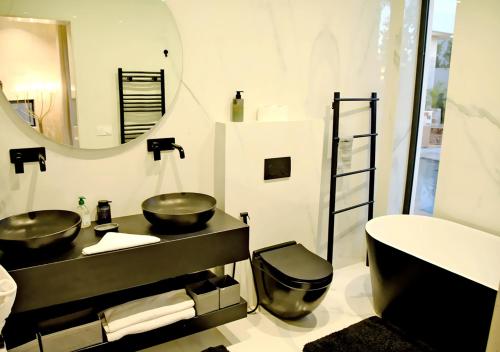 a bathroom with two sinks and a large mirror at Villa Amber in Marrakech