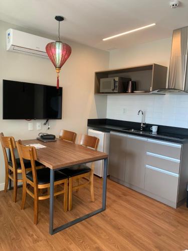 a kitchen and dining room with a table and chairs at Wanderlust Experience Hotel BW Signature - Campos do Jordão in Campos do Jordão