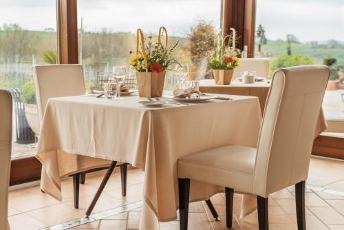 a table with a white tablecloth and chairs in a room at Tenuta Tralice in Ruviano