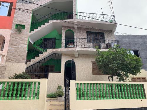 a building with a staircase and a balcony at Ramos Aparttment in São Filipe