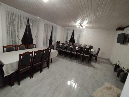 a dining room with tables and chairs in a room at Садиба у Пасічника in Pilipets