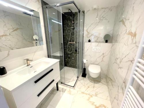 a bathroom with a shower and a sink and a toilet at Alba DeLuxe - 3 Bedroom Pointe Croisette, by Welcome to Cannes in Cannes