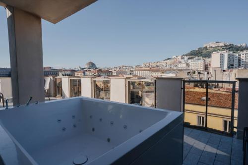 a bath tub on a balcony with a view at POETICA BOUTIQUE SKY HOTEL in Naples