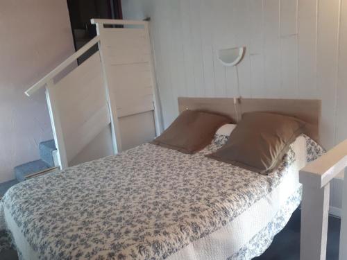 a bedroom with a bed with a canopy and pillows at Gîte les romarins in Le Thoronet