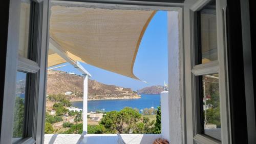 a window with a view of the ocean at Sapsila Patmos Residences in Sapsila