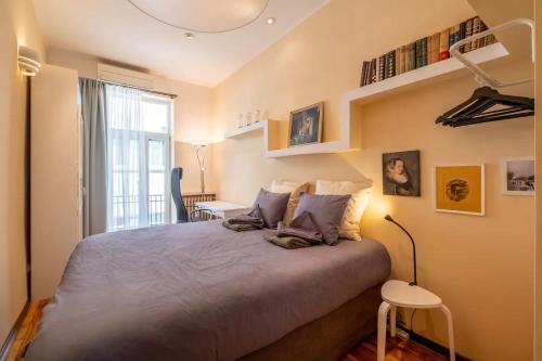 a bedroom with a large bed and a window at Charming 2BDR Apartment in Historic Center With Parking in Sofia