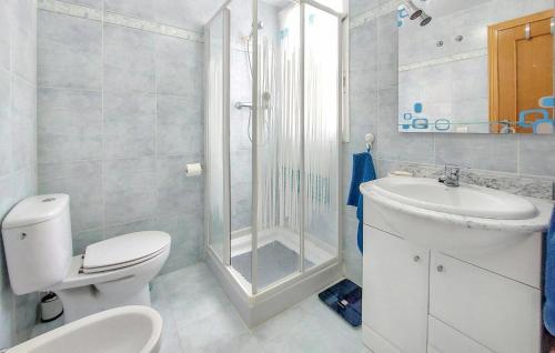a bathroom with a shower and a toilet and a sink at Nice Apartment In Moncofa Playa With Outdoor Swimming Pool in Moncófar