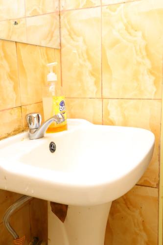 a bathroom sink with a soap bottle on it at SAGE Apartments-South B in Nairobi