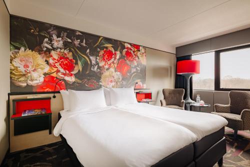 a hotel room with a large bed and a large painting at Leonardo Hotel Den Haag Babylon in The Hague