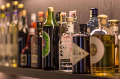 a row of bottles of alcohol sitting on a shelf at Das Graseck - mountain hideaway & health care in Garmisch-Partenkirchen