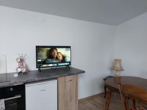 a flat screen tv sitting on a counter in a room at Lymore Guest house in Palamarca