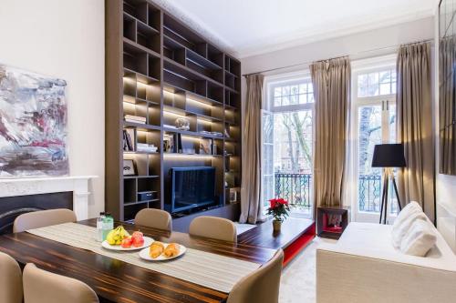 a living room with a table and a television at The One Bramham in London