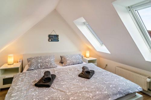 a bedroom with a bed with shoes on it at Ferienwohnung Boje 20 in Schillig