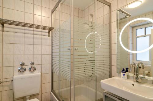 a bathroom with a shower and a sink at Ferienwohnung Boje 20 in Schillig