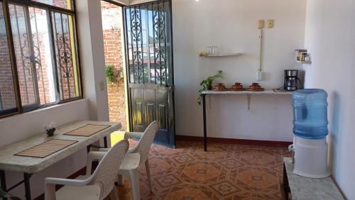 a room with a table and chairs and a table and a window at Luna y Mar in Oaxaca City