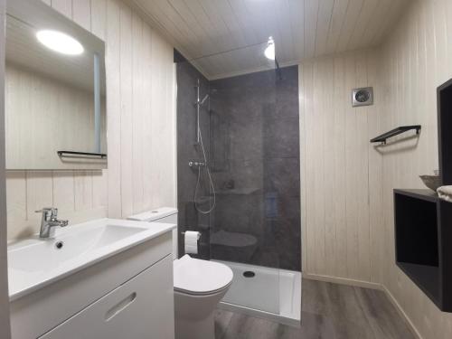 a bathroom with a shower and a sink and a toilet at Nature Nest Aljezur in Aljezur