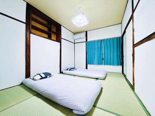 Giường trong phòng chung tại 難波心斎橋10minutes民宿2号室