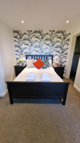 a bedroom with a large bed with towels on it at Rutland Point Studio serviced accommodation Keystones Property Services in Morcott