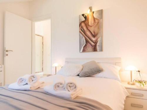 a bedroom with a bed with towels on it at Villa Anita in Gruda