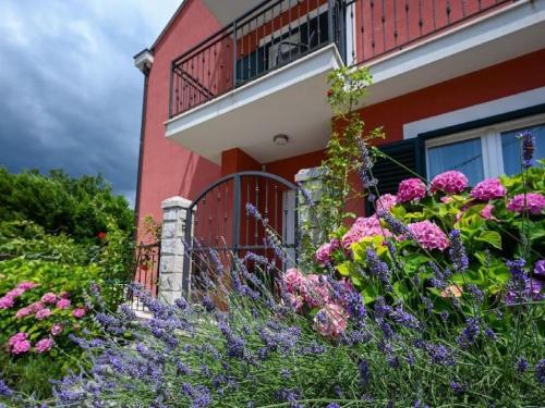 a garden of flowers in front of a house at Villa Anita in Gruda