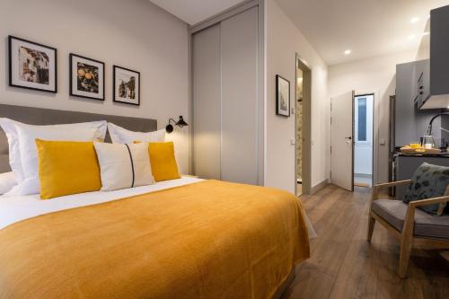 a bedroom with a large bed and a chair at Bonito Loft en Barrio de Chamberi Quevedo I in Madrid