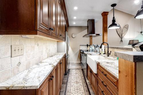 a kitchen with wooden cabinets and marble counter tops at 5123 Foxtail in Wilson