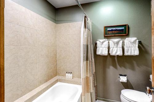 a bathroom with a tub and a toilet at 5123 Foxtail in Wilson